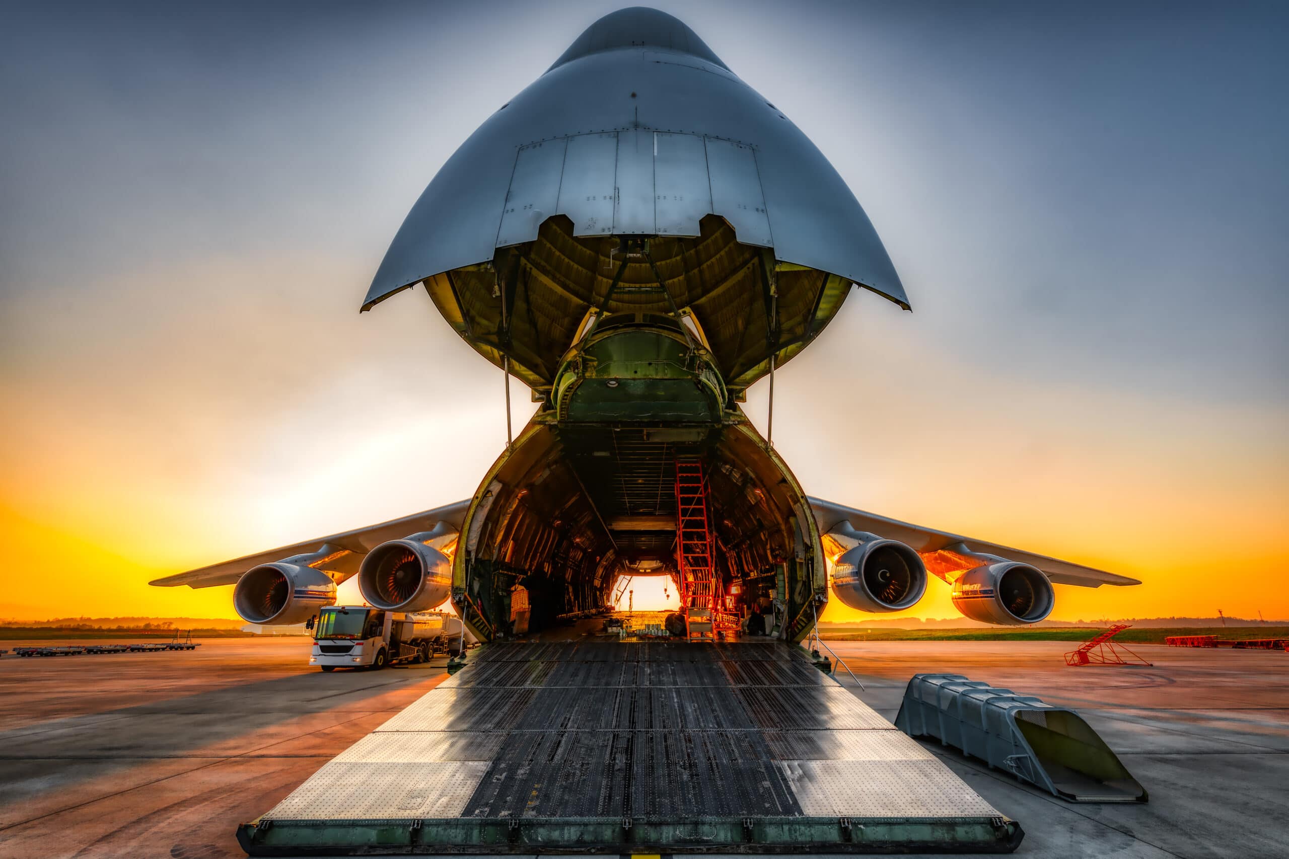 Plane on the ground with wide open freight room, fuel stop